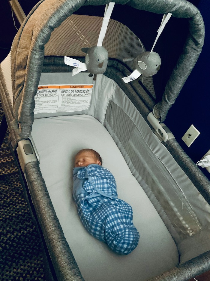 Infant in Chicco LullaGo Nest Portable Bassinet