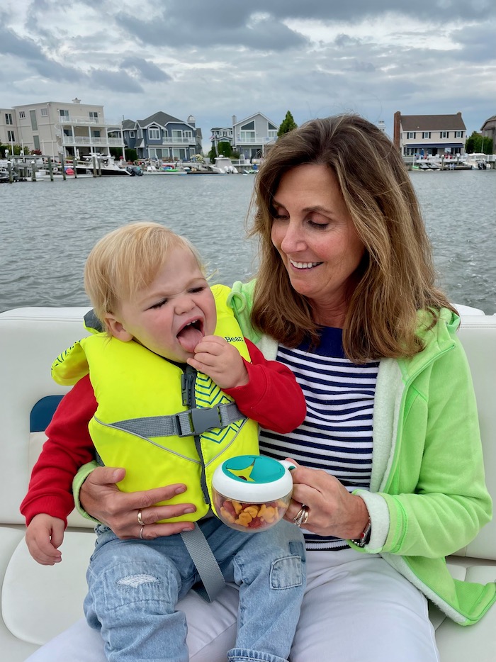 Toddler snacking on a boat