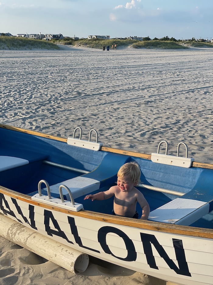 Toddler playing in beach boat