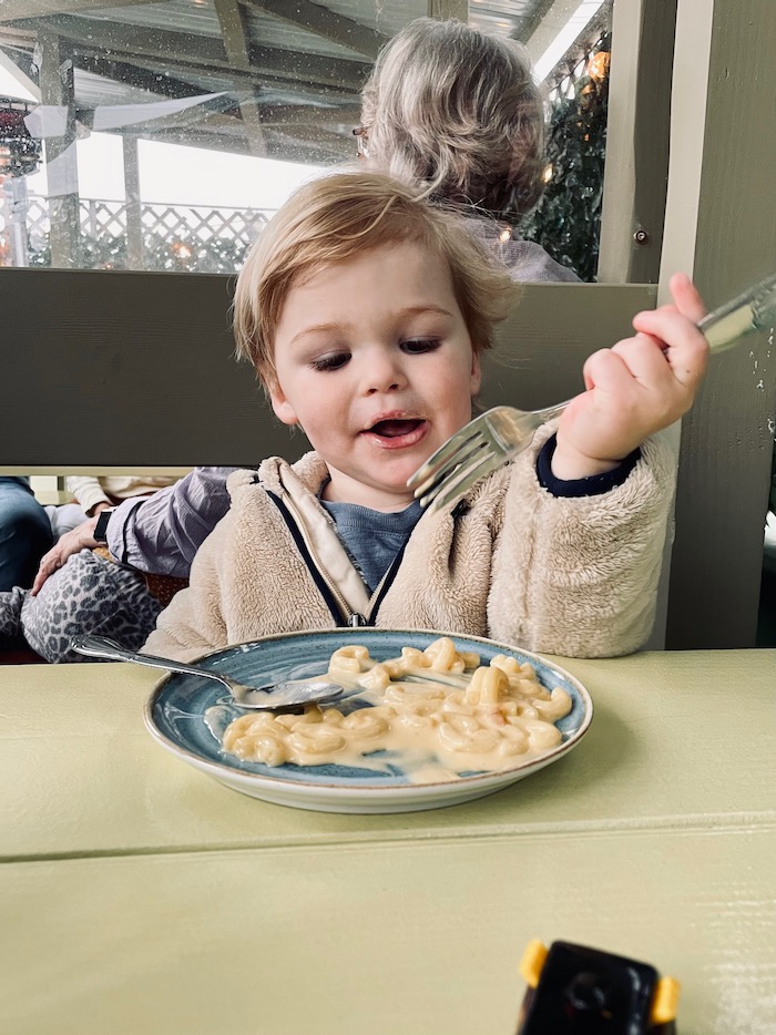 Toddler eating with restaurant fork