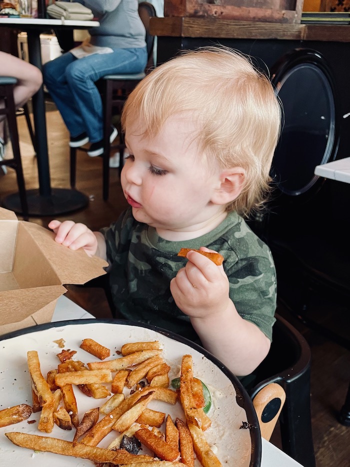 Toddler eating fries