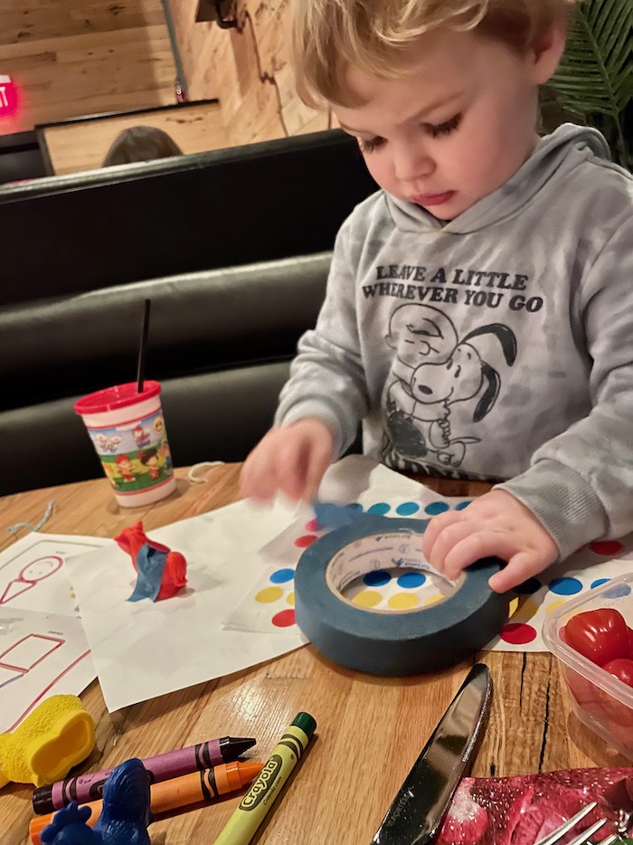 Toddler with restaurant toys