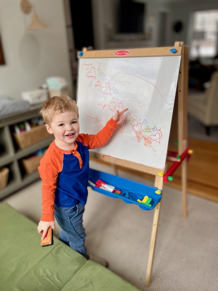 Toddler drawing on Melissa & Doug standing easel