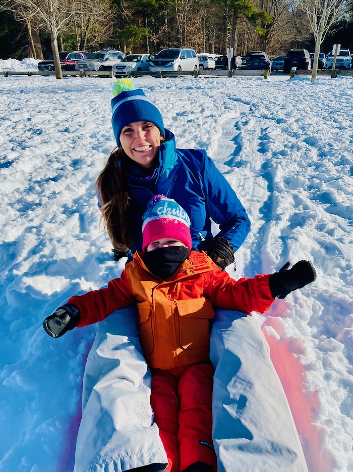 Toddler and mom on a sled