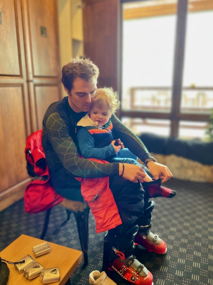 Toddler getting dressed for skiing