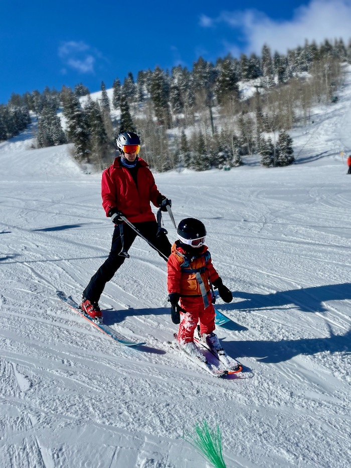 Toddler and dad on skis