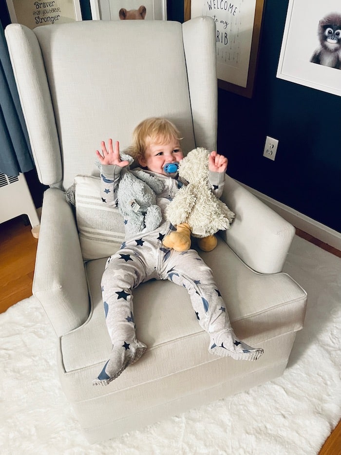 Toddler in swivel glider chair